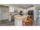 Stylish kitchen showcasing stainless steel appliances, a center island, and ample counter space at 18027 W Tina Ln, Surprise, AZ 85387