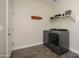 Functional laundry room with modern washer and dryer, and convenient shelving at 18027 W Tina Ln, Surprise, AZ 85387
