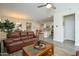 Spacious living area flows into the kitchen featuring a comfortable leather sofa and stylish decor at 18027 W Tina Ln, Surprise, AZ 85387