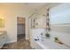 Relaxing main bathroom with a soaking tub, glass-enclosed shower, and a walk-in closet at 18027 W Tina Ln, Surprise, AZ 85387