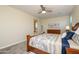 Cozy main bedroom boasts soft carpet and seamlessly connects to the ensuite bathroom and closet at 18027 W Tina Ln, Surprise, AZ 85387