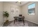 Well-lit home office with a modern desk, comfortable chair, and natural light at 18027 W Tina Ln, Surprise, AZ 85387