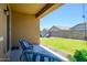 Inviting covered patio with comfortable seating overlooking the landscaped backyard at 18027 W Tina Ln, Surprise, AZ 85387
