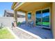 Cozy covered patio with outdoor seating and view of the private backyard at 18027 W Tina Ln, Surprise, AZ 85387