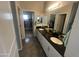 Bathroom featuring double sinks, granite countertop, and a walk-in closet at 1814 W Minton St, Phoenix, AZ 85041