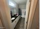 Bathroom featuring double sinks, a bathtub, and neutral tones at 1814 W Minton St, Phoenix, AZ 85041