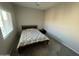 Cozy bedroom featuring a comfortable bed and natural light from a window at 1814 W Minton St, Phoenix, AZ 85041