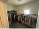 Walk-in closet with ample hanging space and built-in shelving for organized storage at 1814 W Minton St, Phoenix, AZ 85041