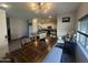 Open-concept kitchen and dining area with pendant lighting, white cabinets, and a wooden dining table set at 1814 W Minton St, Phoenix, AZ 85041