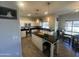 Modern kitchen featuring stainless steel appliances, sleek black countertops, and a functional center island at 1814 W Minton St, Phoenix, AZ 85041
