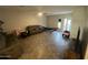 Casual living room with a comfortable sofa, tiled flooring, ceiling fan and a sunlit window at 1814 W Minton St, Phoenix, AZ 85041