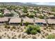 An aerial view showcases the neighborhood with desert landscaping and community at 19102 N 91St St, Scottsdale, AZ 85255