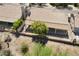 Aerial view of a backyard patio with a lush tree providing shade for outdoor living at 19102 N 91St St, Scottsdale, AZ 85255