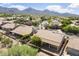 This aerial view shows a cozy covered patio and mature landscaping with mountain views at 19102 N 91St St, Scottsdale, AZ 85255