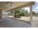 Back patio with ceiling fan overlooking trees and desert landscaping at 19102 N 91St St, Scottsdale, AZ 85255