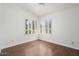 Bright bedroom with hardwood floors, white walls, and shuttered windows offering plenty of natural light at 19102 N 91St St, Scottsdale, AZ 85255