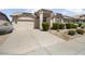 Charming single-story home with a well-manicured front yard, desert landscaping, and a two-car garage at 19102 N 91St St, Scottsdale, AZ 85255
