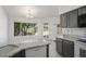 Well-lit kitchen with granite countertops, white appliances, and a view of the backyard at 19102 N 91St St, Scottsdale, AZ 85255