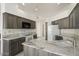 Well-equipped kitchen featuring gray cabinets, granite countertops, and a view into another room at 19102 N 91St St, Scottsdale, AZ 85255