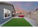 This backyard is perfect for relaxing with a hot tub, artificial grass, and patio seating at 19531 W Palo Verde Dr, Litchfield Park, AZ 85340