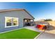 Well-kept backyard with a patio, artificial grass, a hot tub, and comfortable patio seating at 19531 W Palo Verde Dr, Litchfield Park, AZ 85340