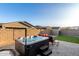 Private backyard features a hot tub, seating area, artificial grass, and a shed for extra storage at 19531 W Palo Verde Dr, Litchfield Park, AZ 85340