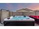 Backyard featuring a hot tub, comfortable seating, and a well-maintained block wall at 19531 W Palo Verde Dr, Litchfield Park, AZ 85340