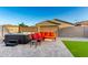 Landscaped backyard featuring a hot tub, seating area, and artificial grass for low maintenance at 19531 W Palo Verde Dr, Litchfield Park, AZ 85340