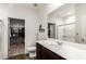 Bright bathroom featuring a large mirror, spacious vanity, and a walk-in closet at 19531 W Palo Verde Dr, Litchfield Park, AZ 85340