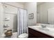 Bathroom with white shower-tub combination, white walls, and dark cabinets at 19531 W Palo Verde Dr, Litchfield Park, AZ 85340
