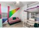 Bedroom with rainbow wall decor, loft bed, desk, and sofa at 19531 W Palo Verde Dr, Litchfield Park, AZ 85340