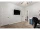 Bedroom with mounted television, desk, and ensuite bath at 19531 W Palo Verde Dr, Litchfield Park, AZ 85340