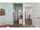 Bedroom with view of hallway with wood floors, light blue walls, and blue butterfly wall light at 19531 W Palo Verde Dr, Litchfield Park, AZ 85340