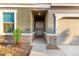 Inviting front entrance featuring a secure screen door, desert landscaping, and a two-car garage at 19531 W Palo Verde Dr, Litchfield Park, AZ 85340
