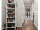 Long hallway featuring wood floors, white walls, neutral colors, and well-lit space at 19531 W Palo Verde Dr, Litchfield Park, AZ 85340