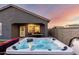 Enjoy the backyard's in-ground hot tub and covered patio with its own barbecue for luxurious outdoor living at 19531 W Palo Verde Dr, Litchfield Park, AZ 85340