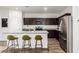 Stylish kitchen features stainless steel appliances, granite countertops and convenient breakfast bar seating at 19531 W Palo Verde Dr, Litchfield Park, AZ 85340