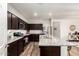 Spacious kitchen boasts granite countertops, stainless appliances, and an island with bar seating at 19531 W Palo Verde Dr, Litchfield Park, AZ 85340