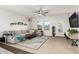 Inviting living room with comfortable seating, a ceiling fan, and bright natural light at 19531 W Palo Verde Dr, Litchfield Park, AZ 85340