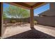 Covered back patio with beautiful stone pavers and desert landscaping at 1965 N 213Th Dr, Buckeye, AZ 85396