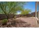 Low maintenance gravel backyard with block wall and desert landscaping for privacy at 1965 N 213Th Dr, Buckeye, AZ 85396