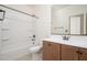 Bathroom features a shower-tub combo, vanity with a sink and cabinets at 1965 N 213Th Dr, Buckeye, AZ 85396