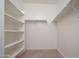 Walk-in closet featuring built-in shelving at 1965 N 213Th Dr, Buckeye, AZ 85396