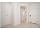 Bright entryway featuring neutral paint and tile flooring, leading into the home at 1965 N 213Th Dr, Buckeye, AZ 85396