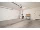 Spacious garage with concrete flooring, overhead lighting and storage workbench area at 1965 N 213Th Dr, Buckeye, AZ 85396