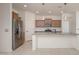 Modern kitchen featuring stainless steel appliances, granite countertops, and ample cabinet space at 1965 N 213Th Dr, Buckeye, AZ 85396