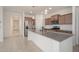 Well-lit kitchen boasting granite countertops, stainless steel appliances, and stylish pendant lighting at 1965 N 213Th Dr, Buckeye, AZ 85396