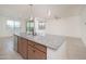 Open kitchen features granite countertops, stainless steel appliances, and a breakfast bar at 1965 N 213Th Dr, Buckeye, AZ 85396