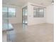 Spacious living room featuring neutral paint, tile flooring, and sliding glass doors to the patio at 1965 N 213Th Dr, Buckeye, AZ 85396