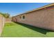 Low-maintenance backyard with artificial turf and secure fencing at 19889 W Sherman St, Buckeye, AZ 85326